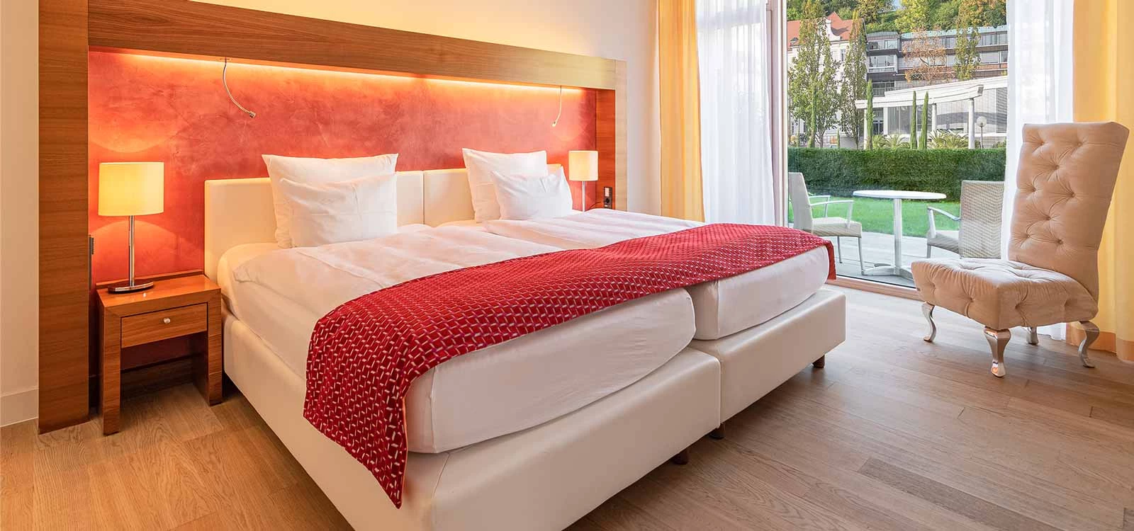 Bed in suite hotel with thermal spa in background